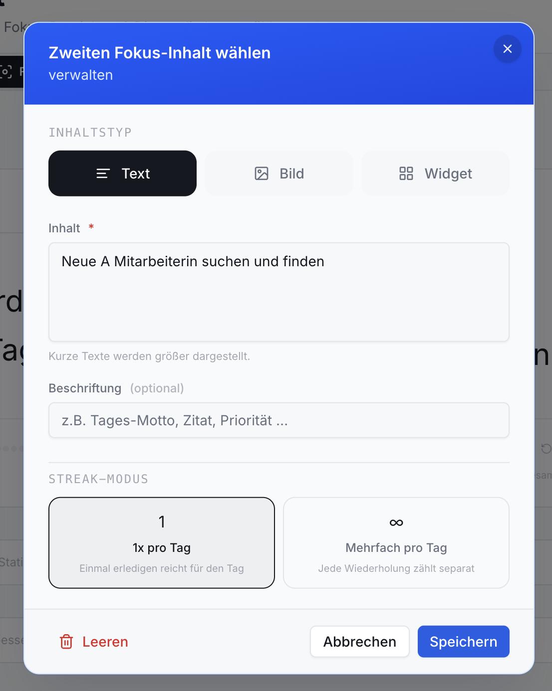 Dialog zur Fokus-Inhalt-Konfiguration. Inhaltstyp Text aktiv, mit Eingabe Neue Mitarbeiterin suchen. Streak-Modus 1x/Tag. Speichern/Abbrechen Buttons.